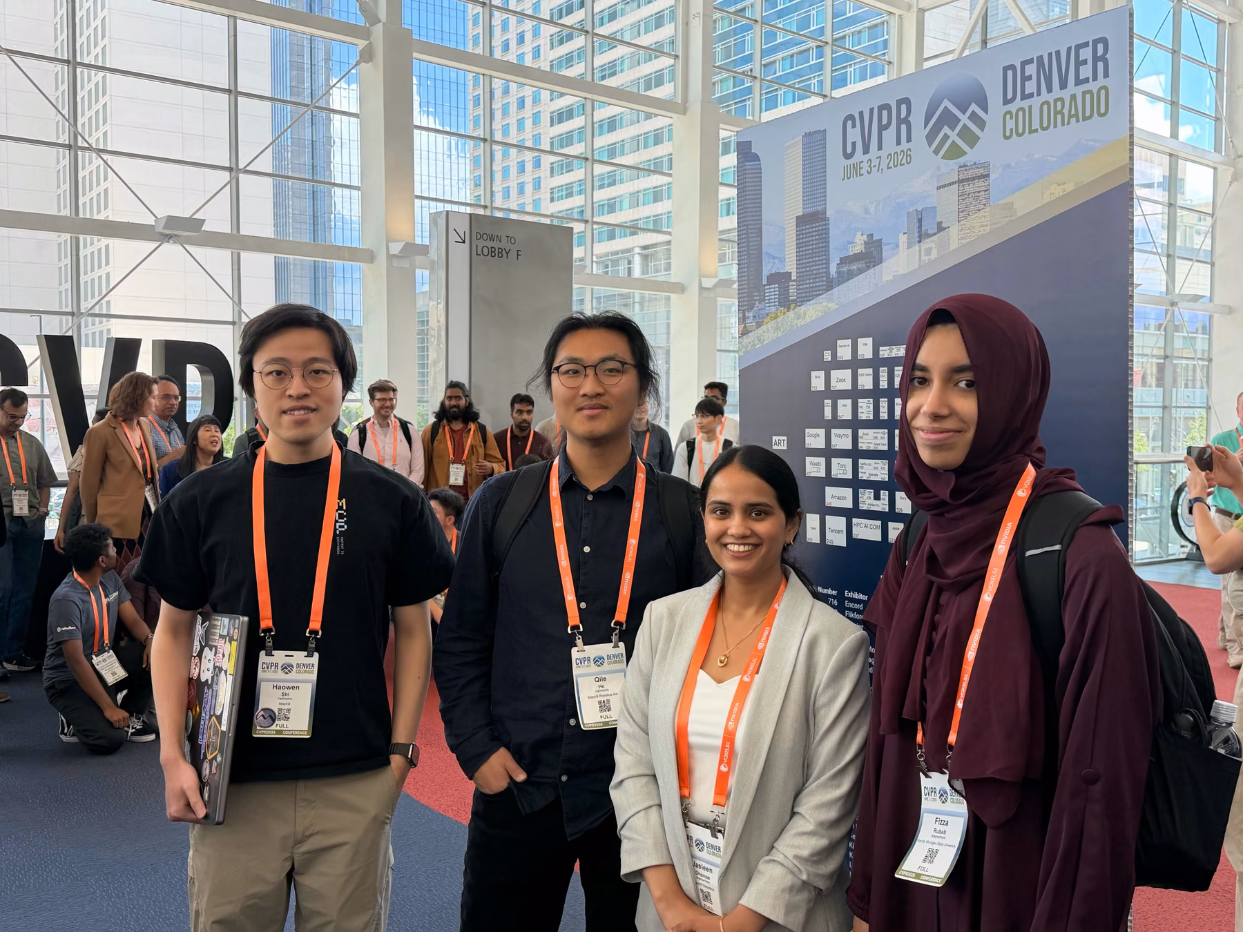 Four Mach9 team members in front of the CVPR Denver conference sign