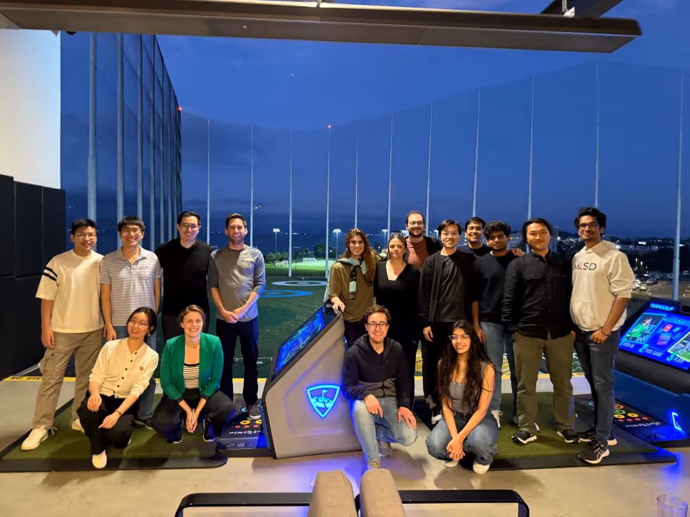 The team gathered for a group photo at an evening offsite
